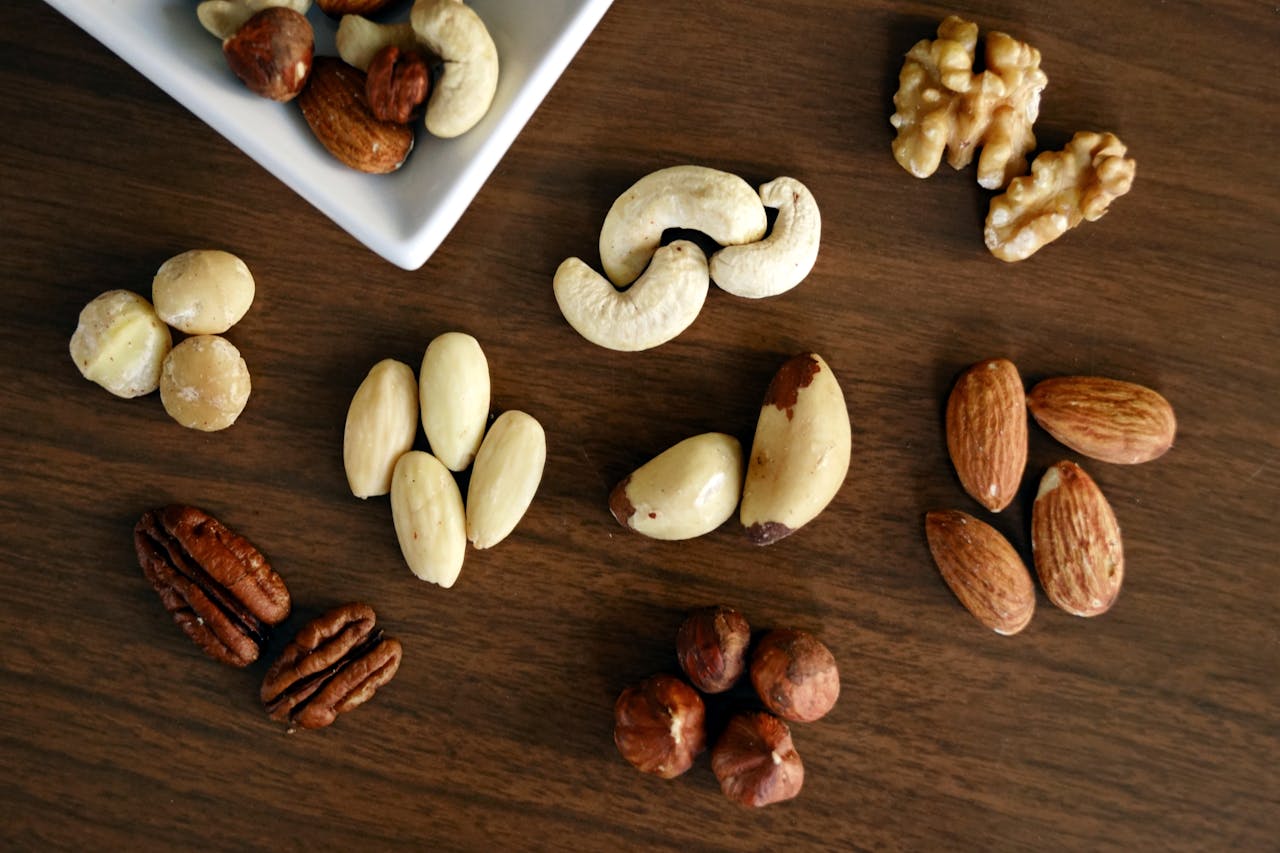 A variety of nutritious nuts arranged on a table, showcasing healthy snack options rich in protein and essential nutrients. Perfect for health tips on balanced eating and wellness.