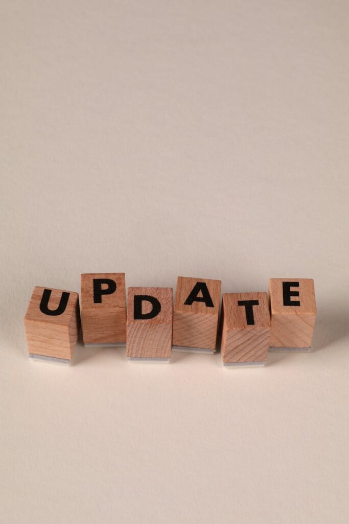 Wooden blocks spelling 'UPDATE' on a neutral background, perfect for business and communication themes.